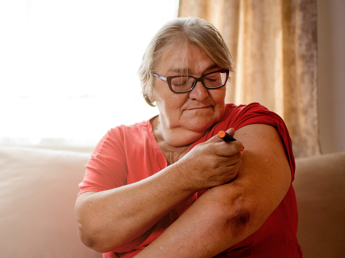 Woman giving a GLP-1 medication injection to herself