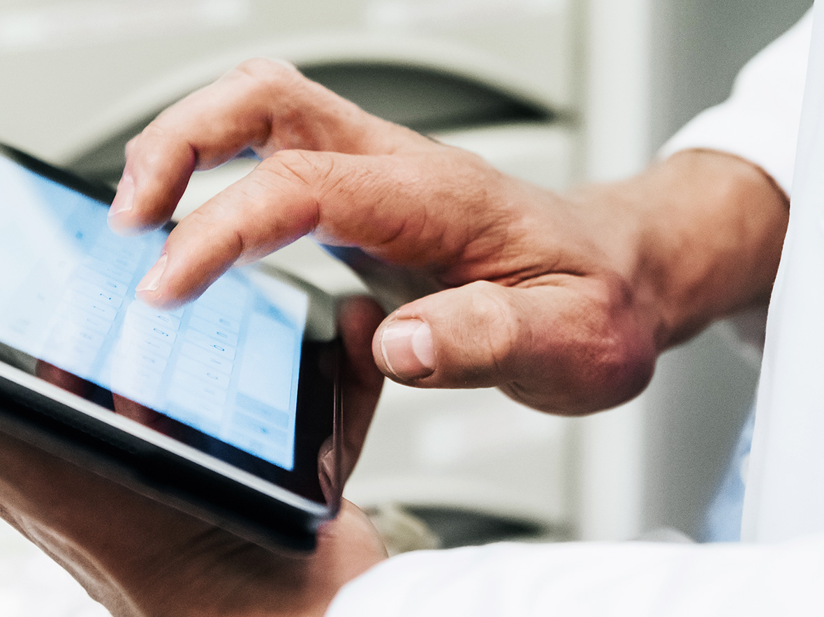 Close up picture of person typing on an ipad screen